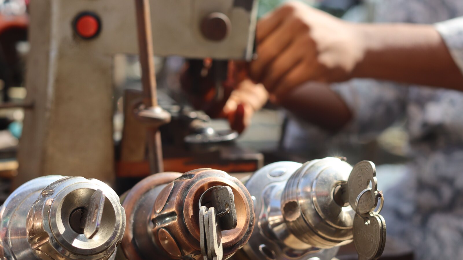A locksmith cutting keys at the workbench